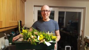 John with tray of posies